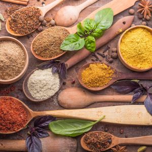 Various herbs and spices in wooden spoons